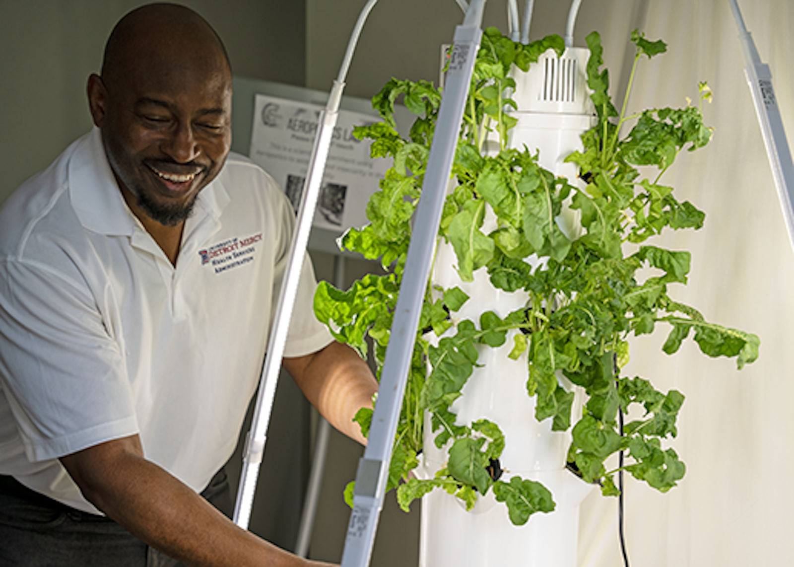 Olla tends to the plants in the center's aeroponics garden, which is one example of the use of emerging technologies that can utilize artificial intelligence applications to improve the lives of those in the local community, he said.